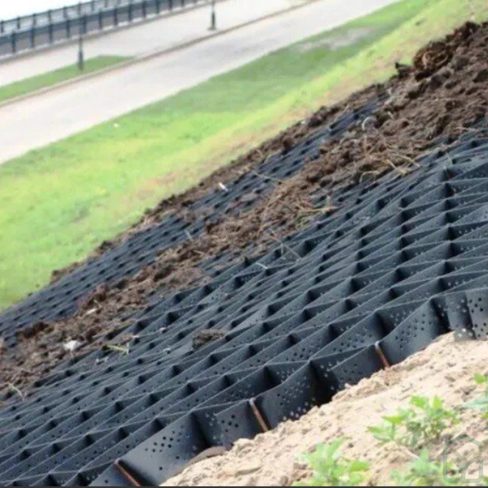 BaseCore geocell installed on a graded embankment with topsoil cover