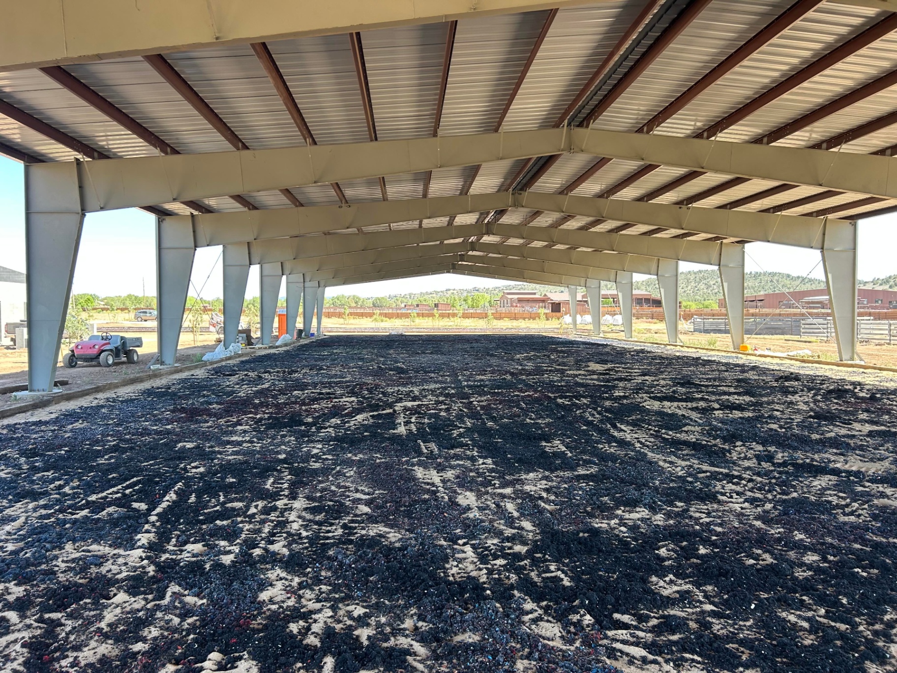 Levitare equestrian footing freshly installed in a covered arena before blending into the sand surface