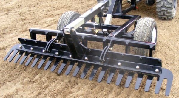 Close-up of the Arena Rake's adjustable arena comb and scarifier shanks