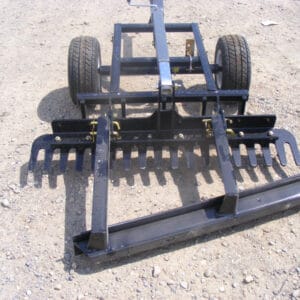 An Arena Rake attached to a tractor.