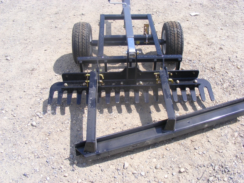 An Arena Rake attached to a tractor.