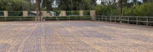 A concrete floor with a fence and trees in the FAQ.