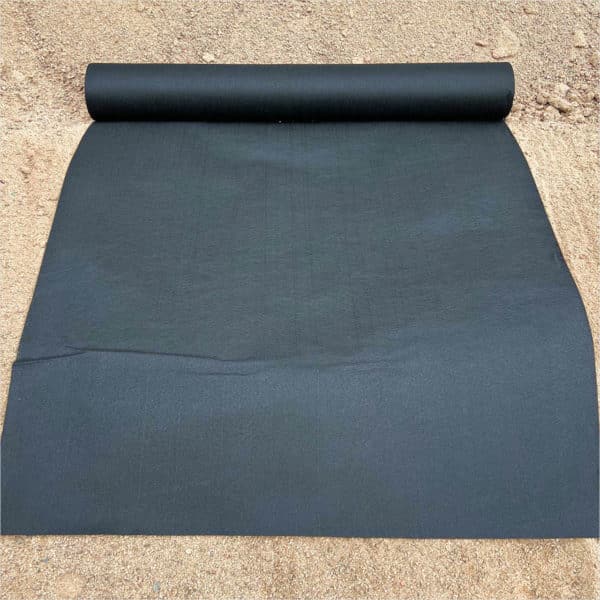 A roll of black Geotextile sitting on the ground.