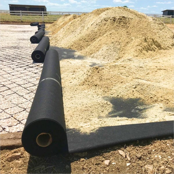 A Geotextile tarp is sitting on top of a pile of sand.