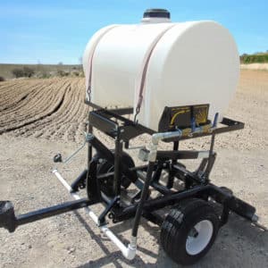 A water tank on a trailer in a field, equipped with Water Kits AR.