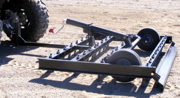 A black ATV modified with an Arena Dragster wheel attached to it.