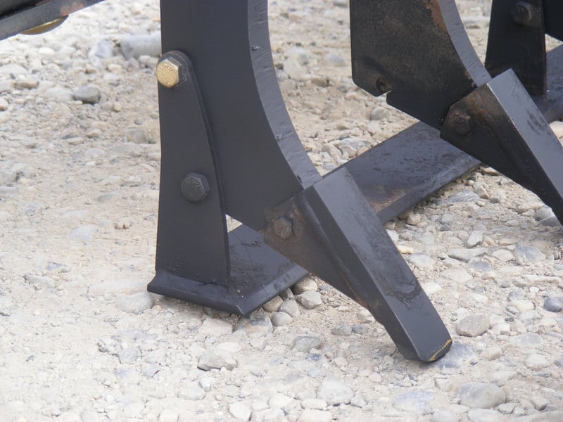 A close up of a black metal plow featuring a Profiler Bar.