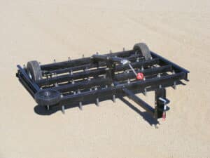 An Arena Dragster equipped with a plow, ideal for maneuvering across various surfaces.