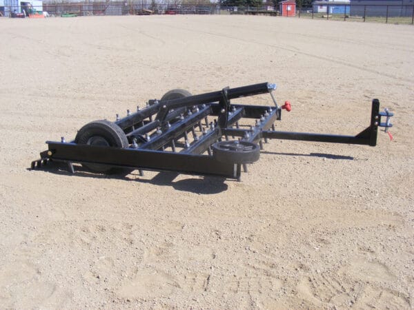 An Arena Dragster with a plow attached to it.