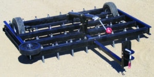 An Arena Dragster, with a rake attached to it.