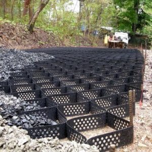 A large pile of rocks and gravel in a wooded area.