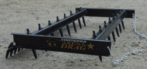An Arena Drag is attached to a metal rake.