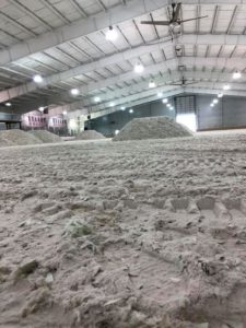 A large pile of sand in an indoor arena.