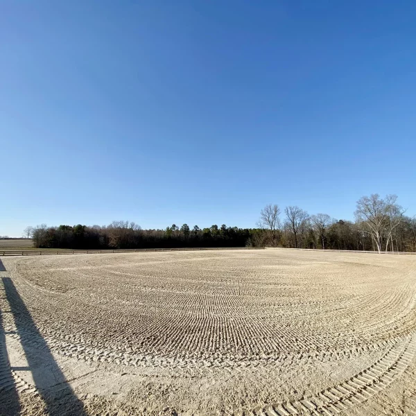 An aerial view of a field with a tire track in the middle at ArenaGreen.