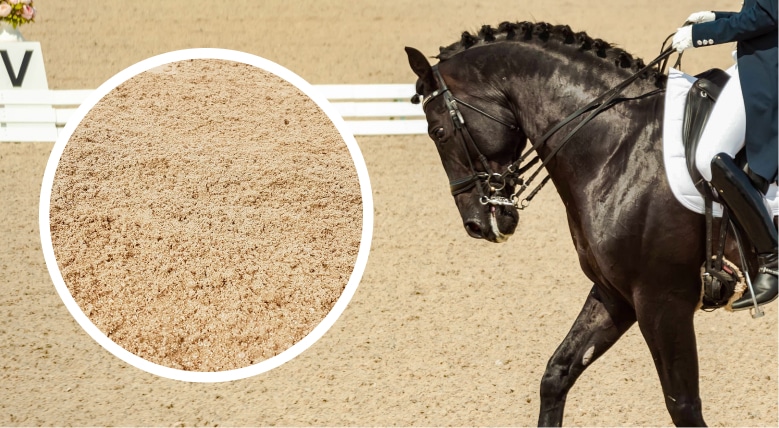 A woman is riding a horse in an equestrian competition on Arena Footing Solutions. A woman is riding a horse in an equestrian competition on Arena Footing Solutions.