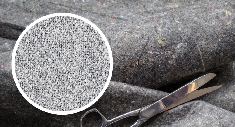 A pair of scissors precisely cutting through a piece of fabric. A pair of scissors precisely cutting through a piece of fabric.