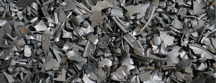 A pile of metal scraps on the ground that showcases the contrast between Rubber Mulch and Foam Footing. A pile of metal scraps on the ground that showcases the contrast between Rubber Mulch and Foam Footing.