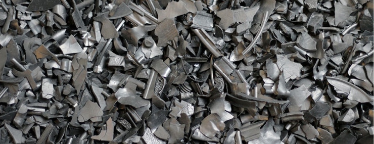 A pile of metal scraps on the ground that showcases the contrast between Rubber Mulch and Foam Footing.