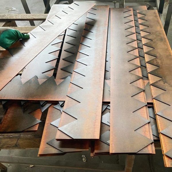 A group of BaseEdge HD Steel Edging pieces on a factory table.
