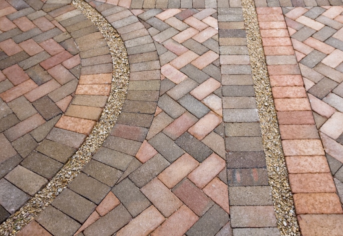 A brick walkway with a circular pattern.