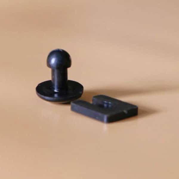 A black plastic button and a black plastic screw from a BaseClips (Pack of 45).