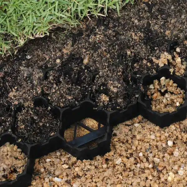 A black plastic garden edging with grass and dirt.