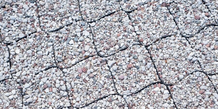 A close up image of a gravel road enhanced with geocells.